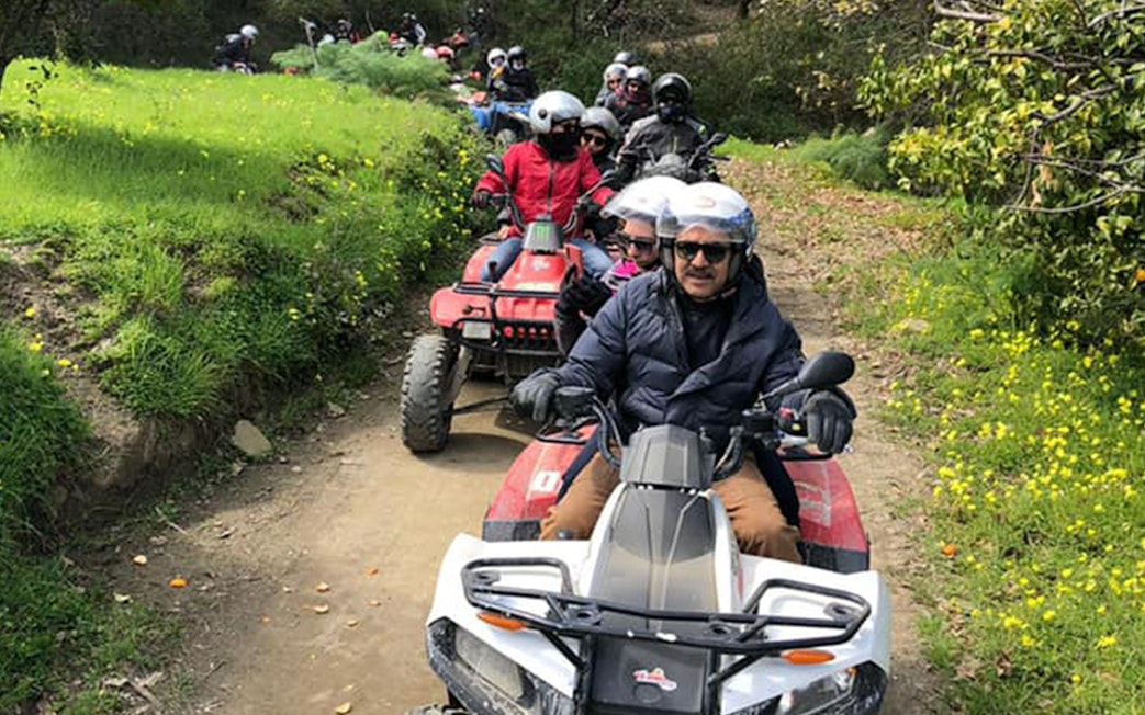 Group riding quad bikes on a trail through Alcantara Gorges, Sicily.