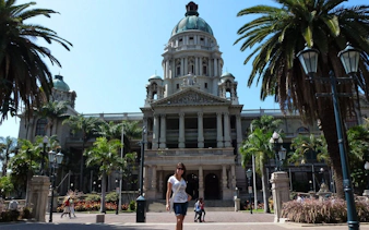 Durban City Hall with palm trees on a sunny day during Half Day Durban City Sightseeing Tour.