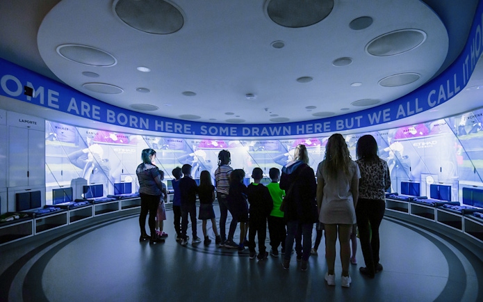 Visitors exploring Manchester City Stadium's interactive exhibit.