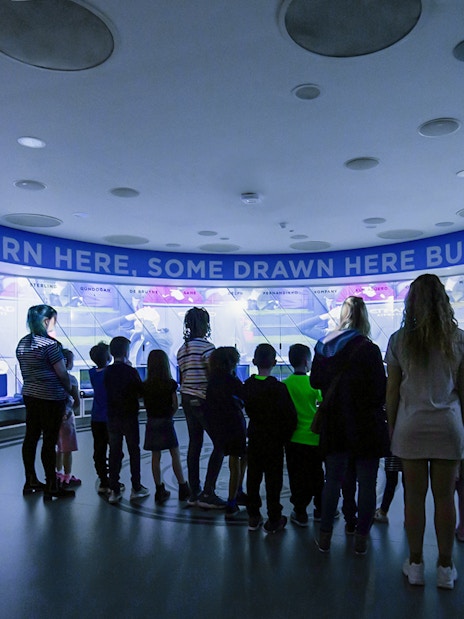 Visitors exploring Manchester City Stadium's interactive exhibit.