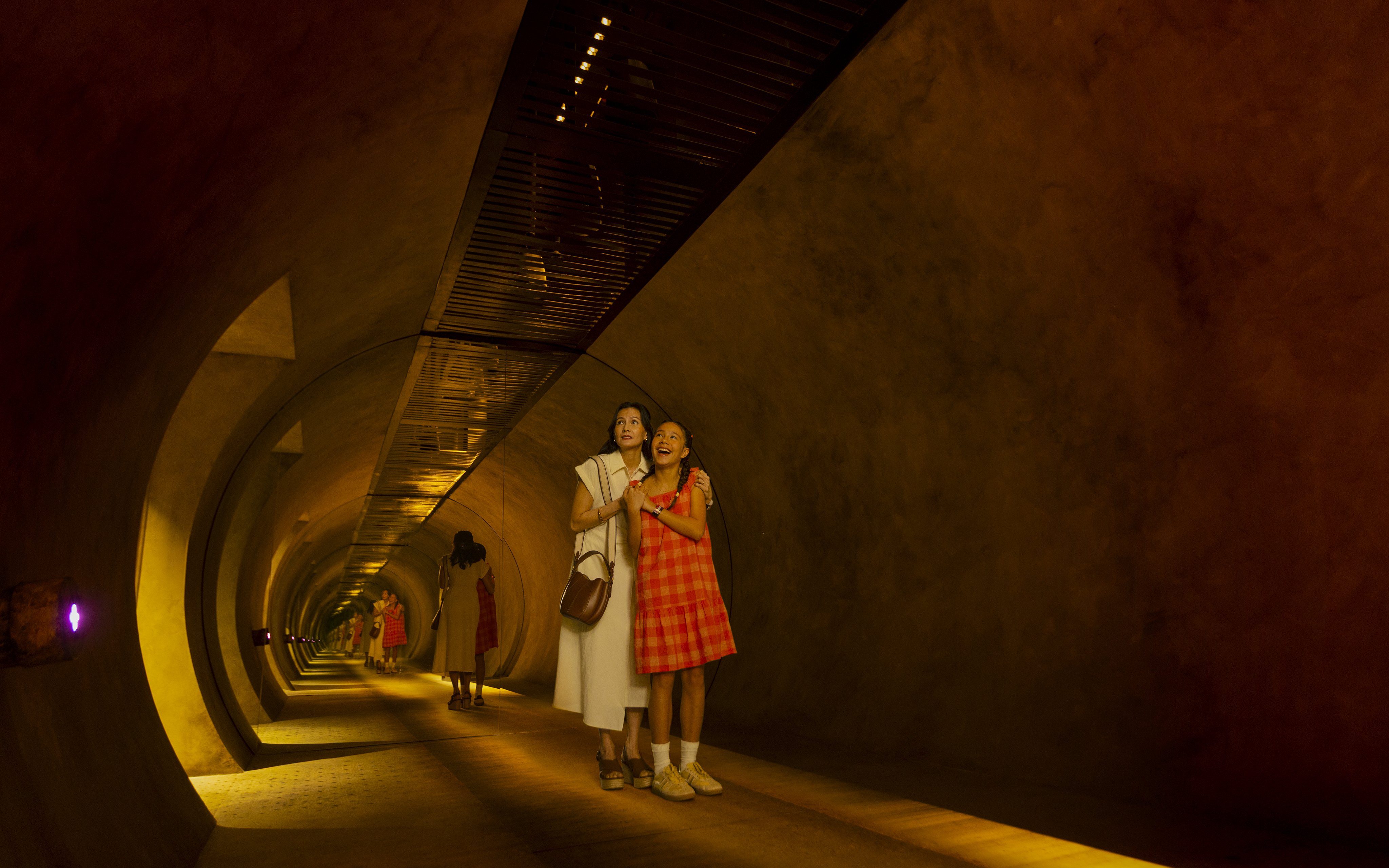 Mother and daughter exploring tunnel at Exploria, Mandai Wildlife.