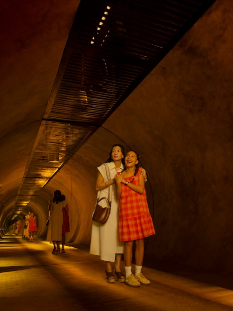 Mother and daughter exploring tunnel at Exploria, Mandai Wildlife.