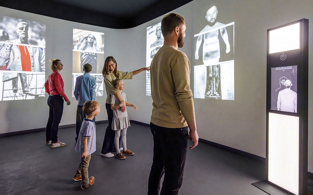 Guests interacting with digital displays at Praga Magica Interactive Exhibition.