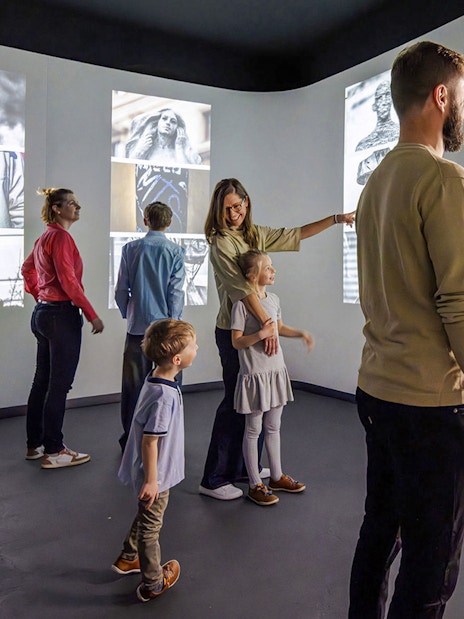Guests interacting with digital displays at Praga Magica Interactive Exhibition.