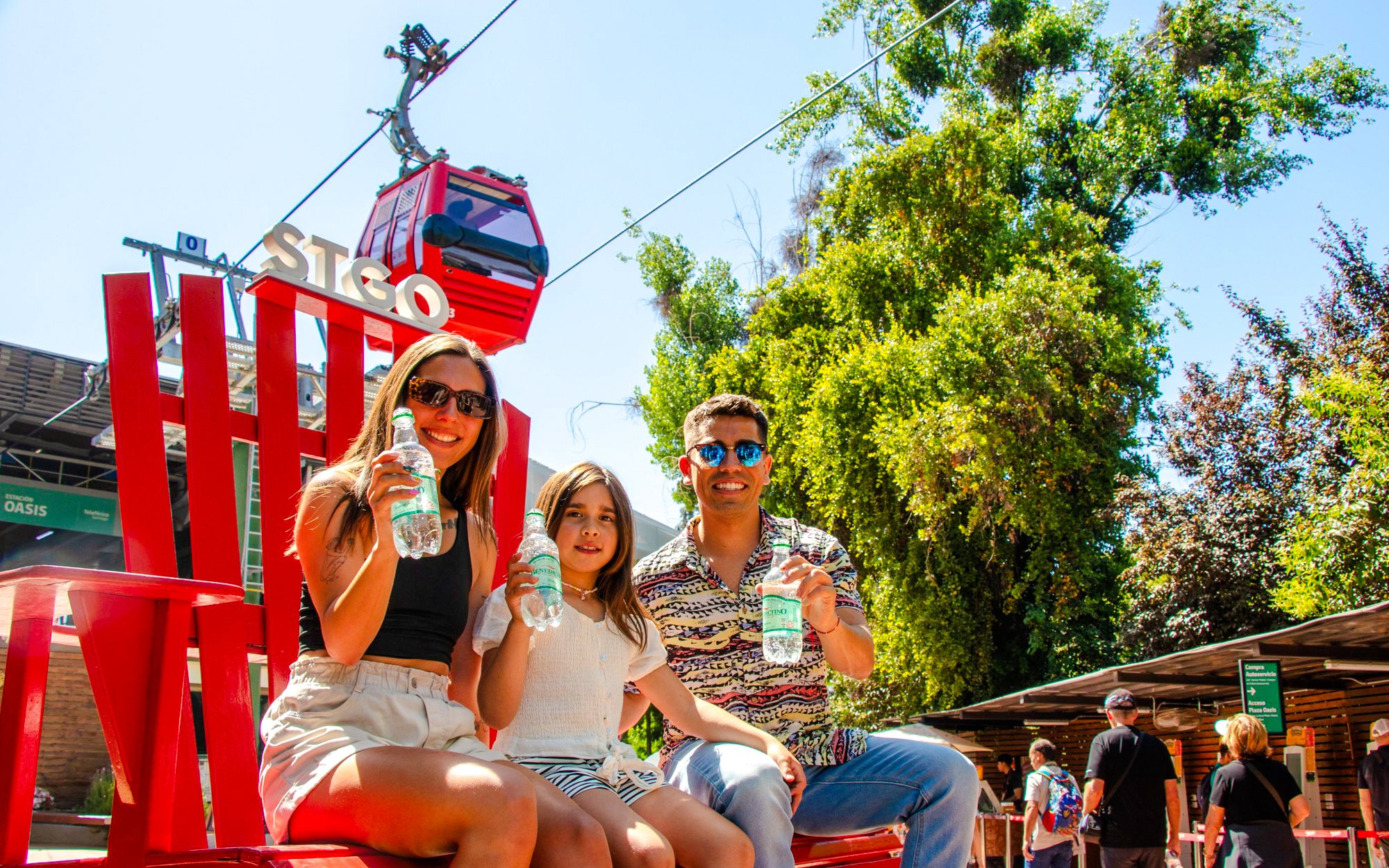 Family enjoying drinks near Santiago cable car station.