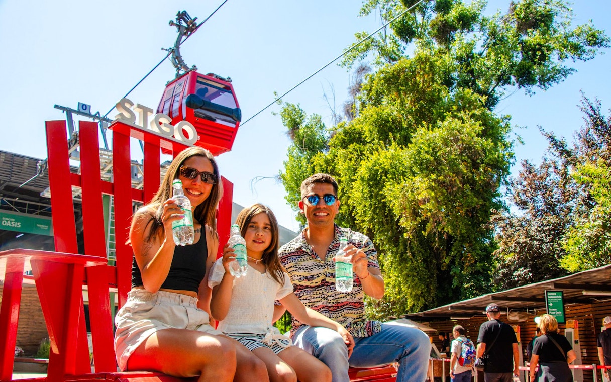 Family enjoying drinks near Santiago cable car station.