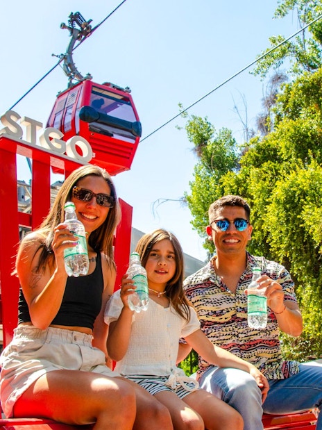 Family enjoying drinks near Santiago cable car station.