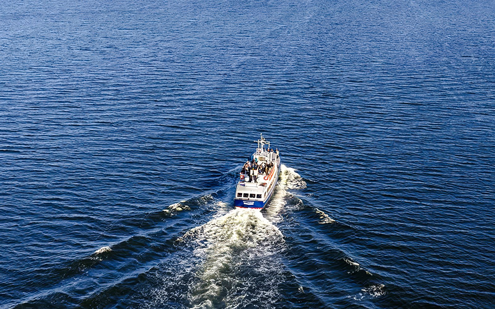 Boat cruising through Stockholm Archipelago waters during tour.