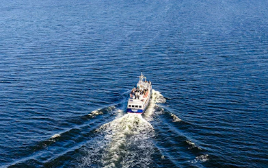 Boat cruising through Stockholm Archipelago waters during tour.