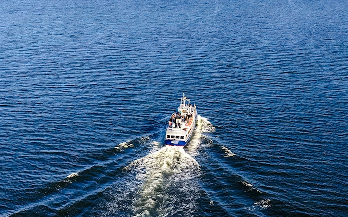 Boat cruising through Stockholm Archipelago waters during tour.