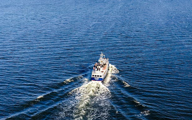 Boat cruising through Stockholm Archipelago waters during tour.