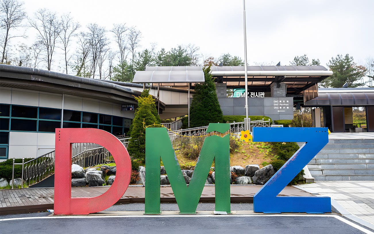 DMZ entrance sign at Paju, South Korea, with pavilion in the background.