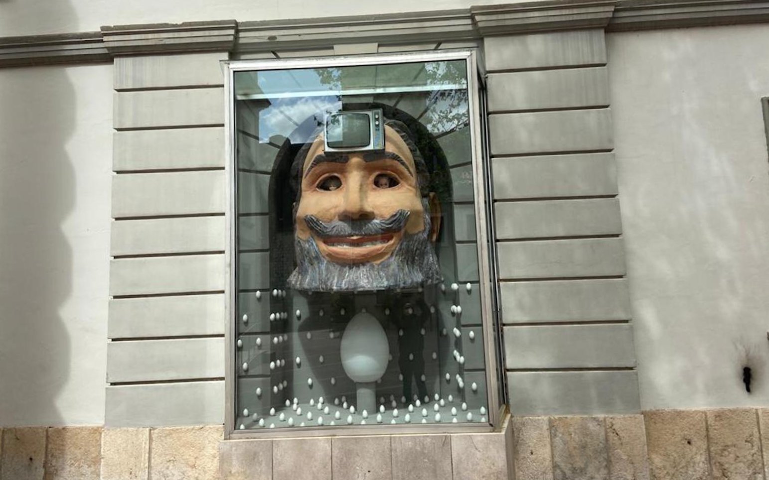 Art installation featuring a large head with a TV at Dalí Theatre-Museum, Figueres, Spain.