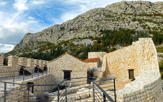 Sokol Grad castle fortress with stone walls and cannons in Croatia.