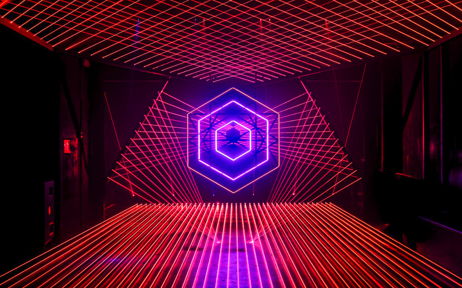 Neon light installation at Amaze Amsterdam with geometric patterns.