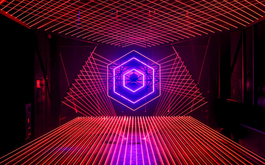 Neon light installation at Amaze Amsterdam with geometric patterns.