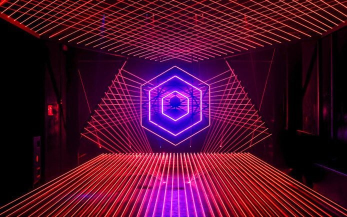 Neon light installation at Amaze Amsterdam with geometric patterns.