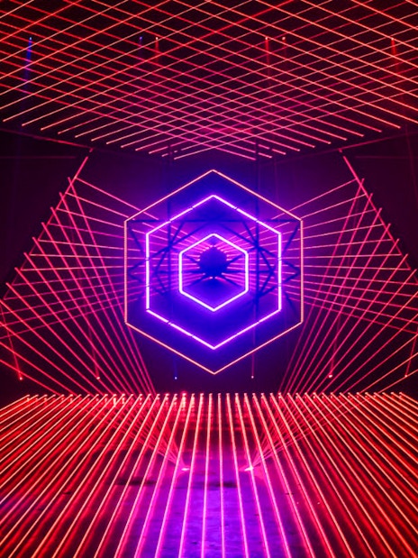 Neon light installation at Amaze Amsterdam with geometric patterns.
