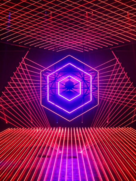 Neon light installation at Amaze Amsterdam with geometric patterns.