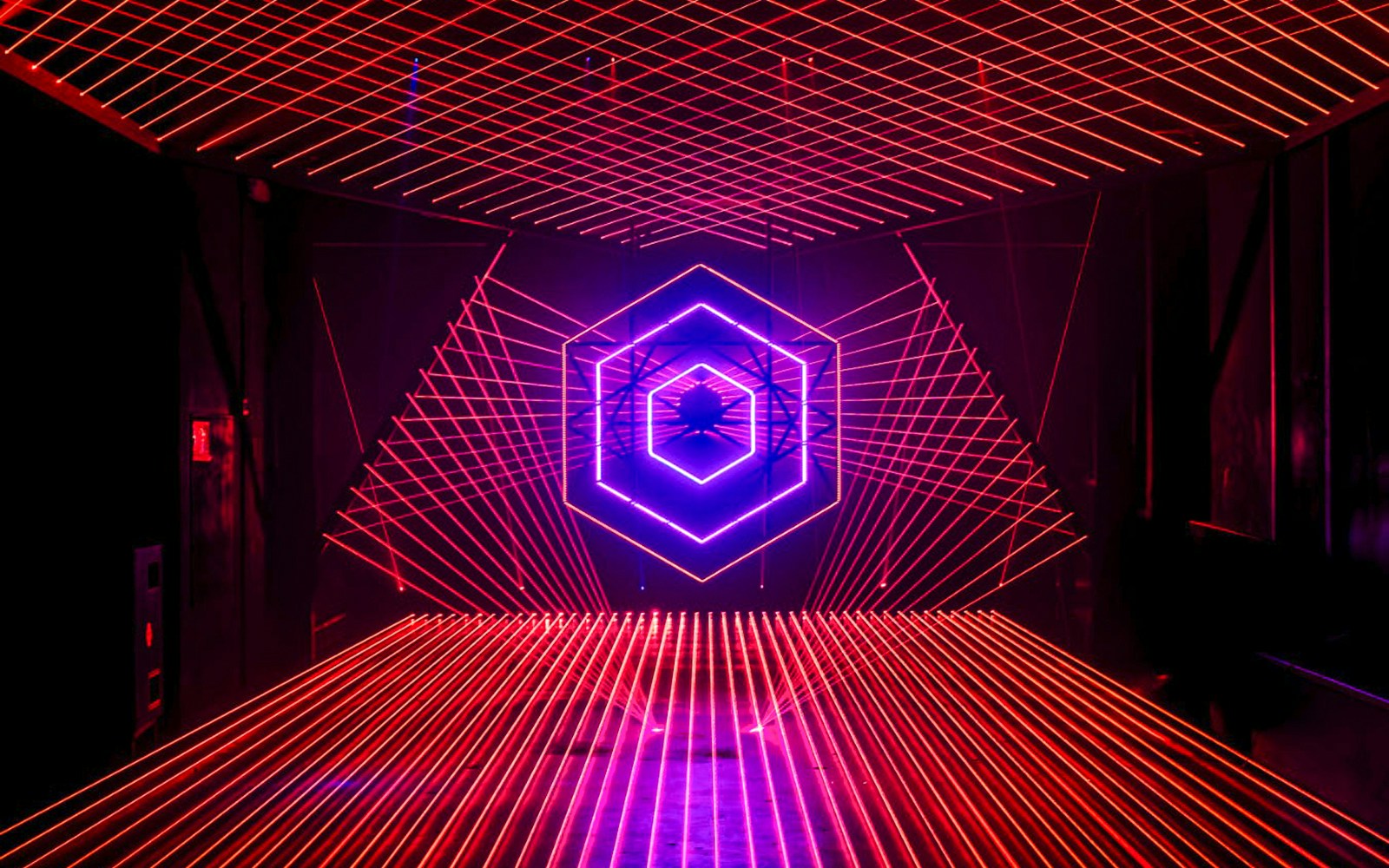 Neon light installation at Amaze Amsterdam with geometric patterns.