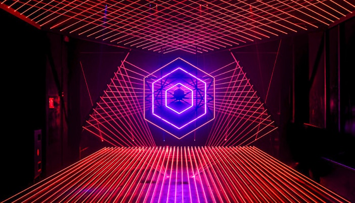 Neon light installation at Amaze Amsterdam with geometric patterns.