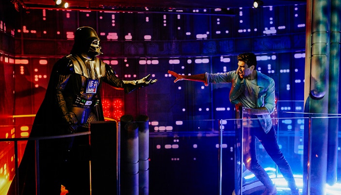 Darth Vader wax figure with visitor at Star Wars zone, Madame Tussauds London.