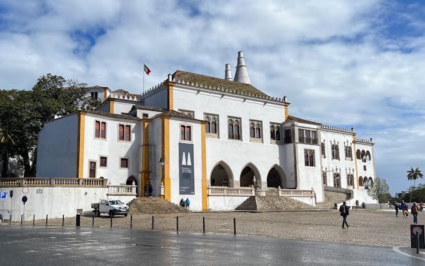 Sintra National Palace exterior with visitors, part of 3-hour guided tour including Quinta da Regaleira and Biester Palace.
