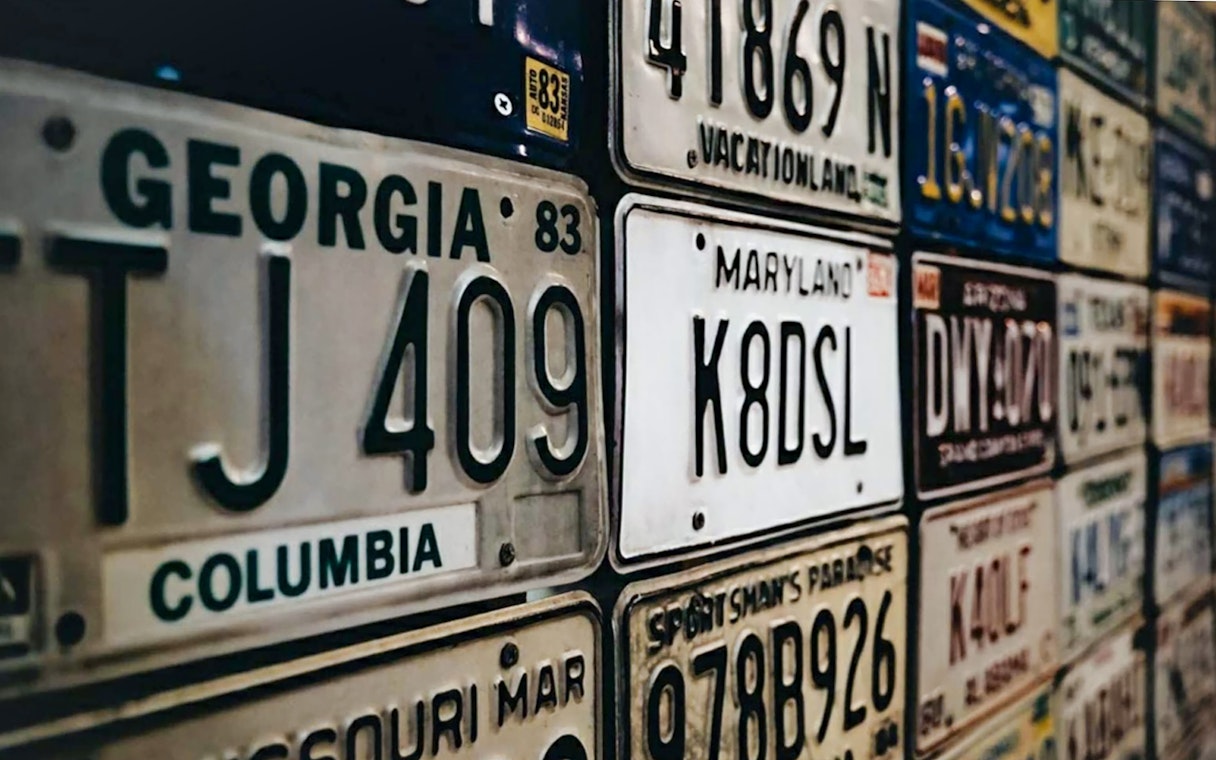 Vintage license plates display at Malta Classic Car Collection Museum.