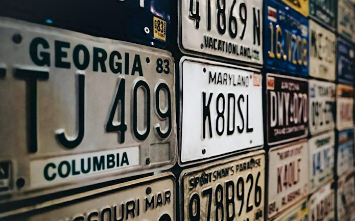 Vintage license plates display at Malta Classic Car Collection Museum.