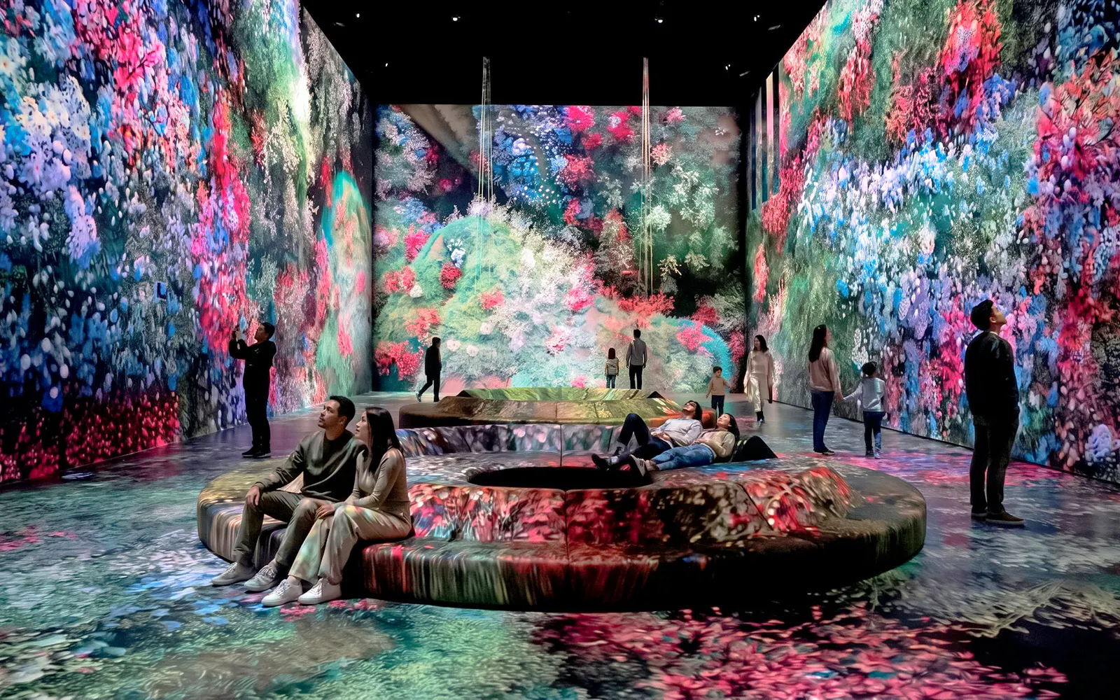 Visitors at Mercer Labs Museum of Art viewing immersive digital floral displays.