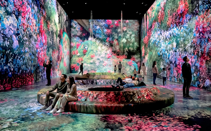 Visitors at Mercer Labs Museum of Art viewing immersive digital floral displays.