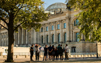 Group of tourists outside the Reichstag building in Berlin during a walking tour.
