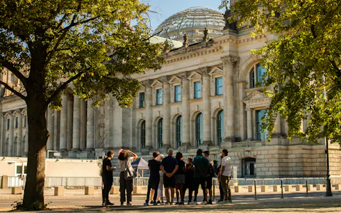 Group of tourists outside the Reichstag building in Berlin during a walking tour.
