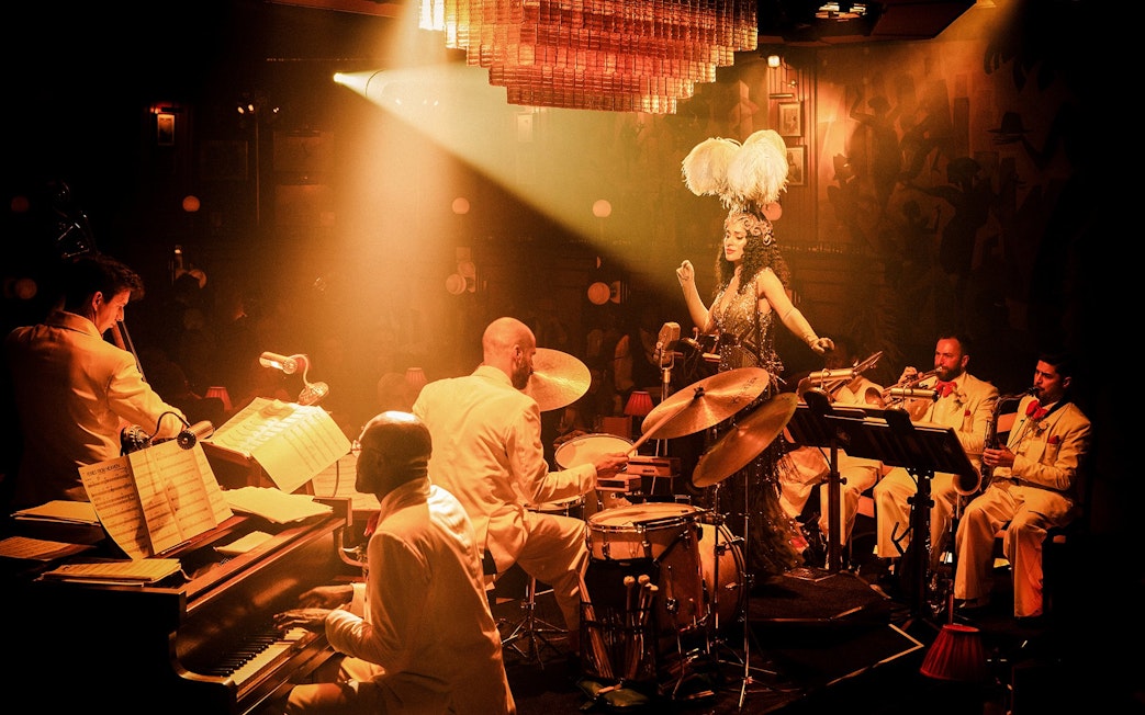 Jazz band performing on 58th Street with a singer in feathered headpiece.