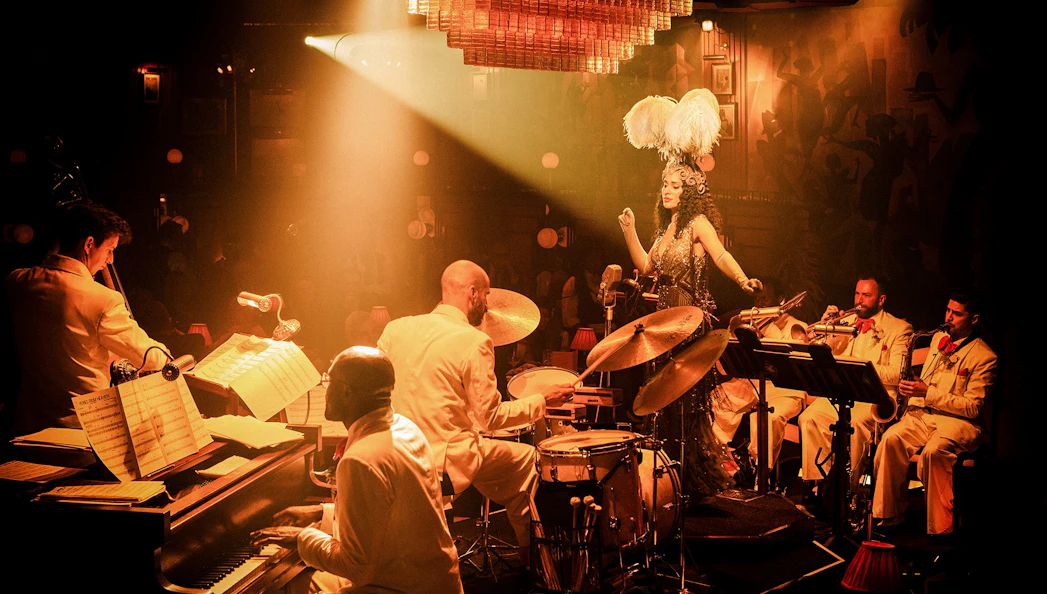 Jazz band performing on 58th Street with a singer in feathered headpiece.