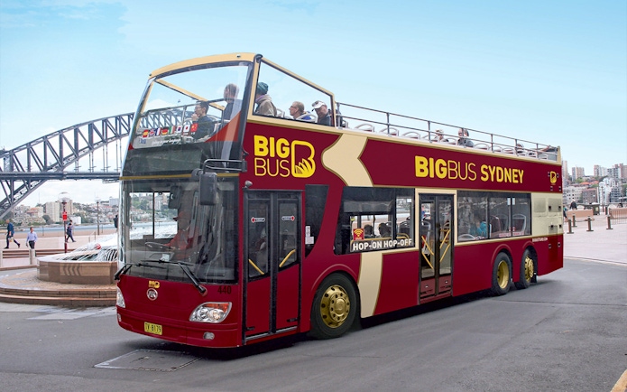 Big Bus Sydney tour with Sydney Harbour Bridge in the background.