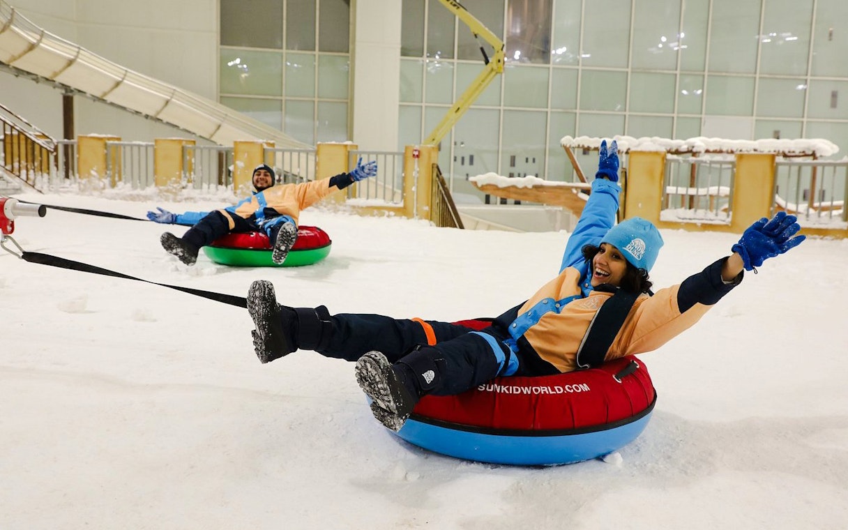 Visitors enjoying snow tubing at Snow Dunes Theme Park.