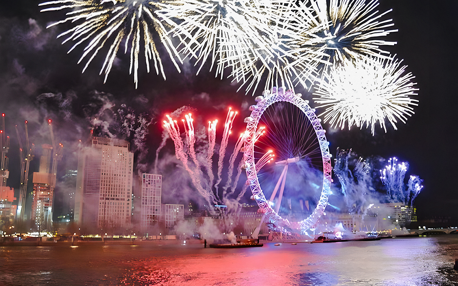 Fireworks over the London Eye on New Year's Eve, River Thames, London.
