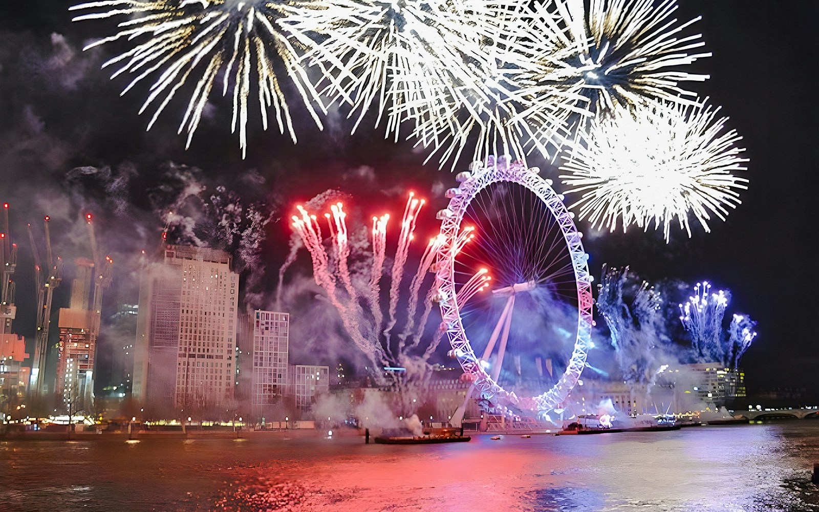 Fireworks over the London Eye on New Year's Eve, River Thames, London.