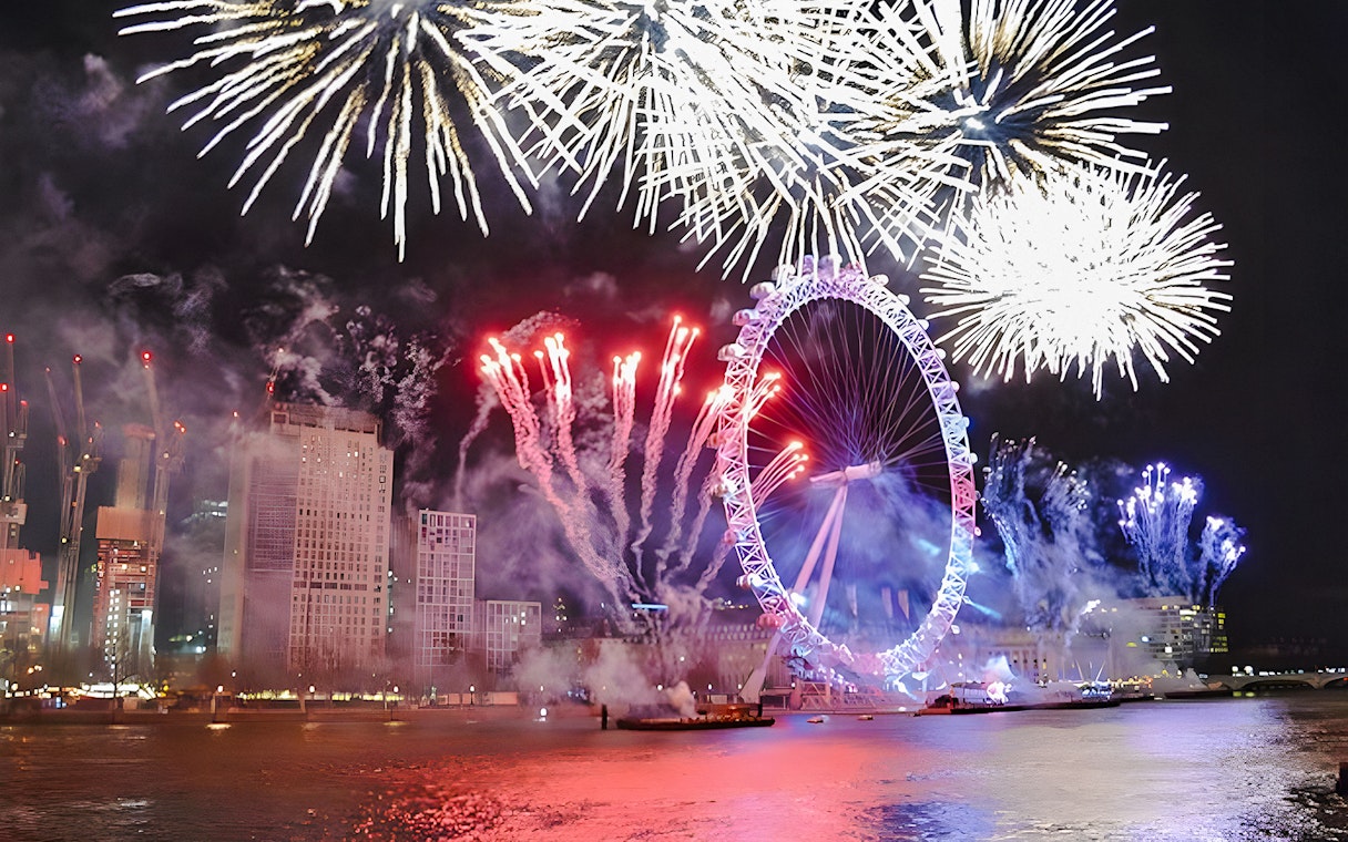 Fireworks over the London Eye on New Year's Eve, River Thames, London.