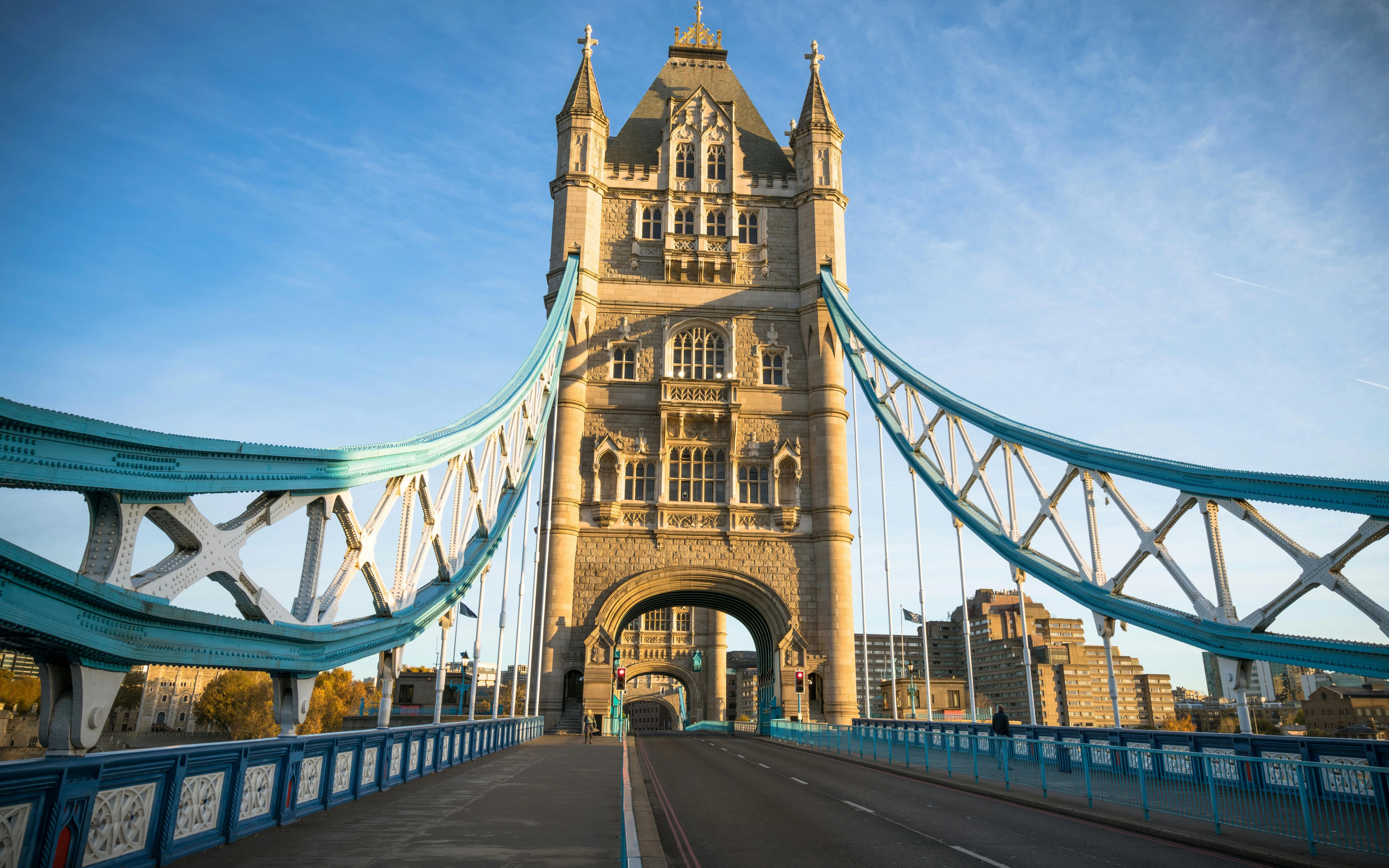 Tower Bridge in London with empty road and blue sky.