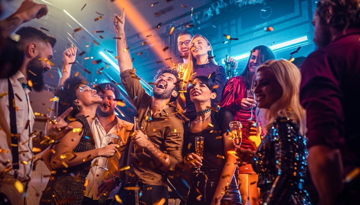 party with people celebrating and confetti falling.