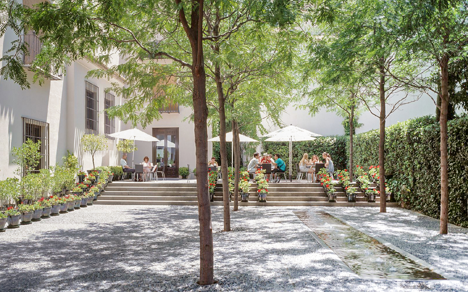 Visitors enjoying outdoor seating at Picasso Museum Malaga cafe.