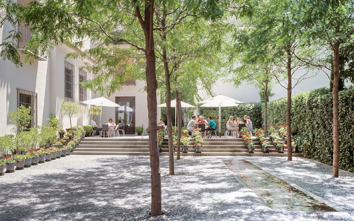 Visitors enjoying outdoor seating at Picasso Museum Malaga cafe.