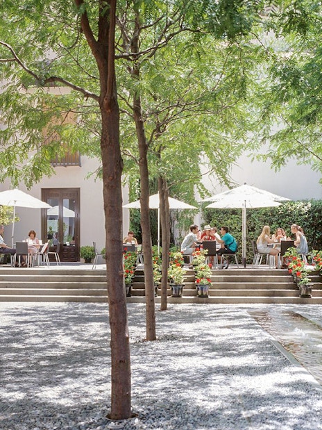 Visitors enjoying outdoor seating at Picasso Museum Malaga cafe.