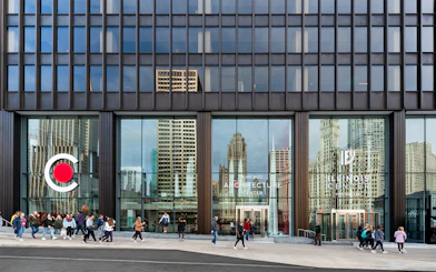 Exterior facade of the Chicago Architecture Center with people walking by.