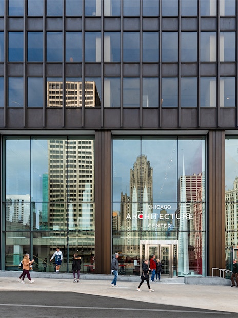 Exterior facade of the Chicago Architecture Center with people walking by.