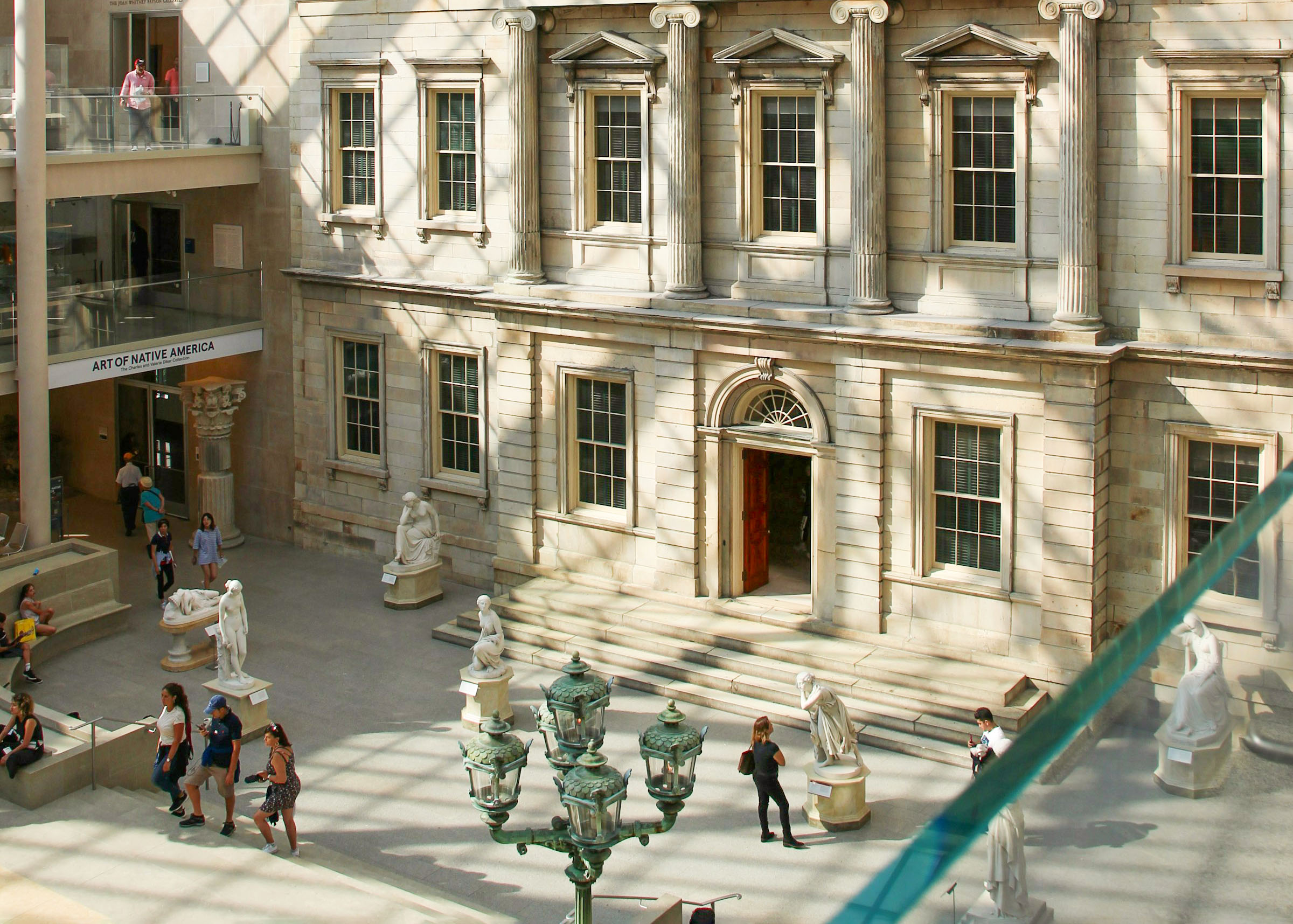 Metropolitan Museum of Art interior court, New York City, showcasing classical sculptures and architectural details.