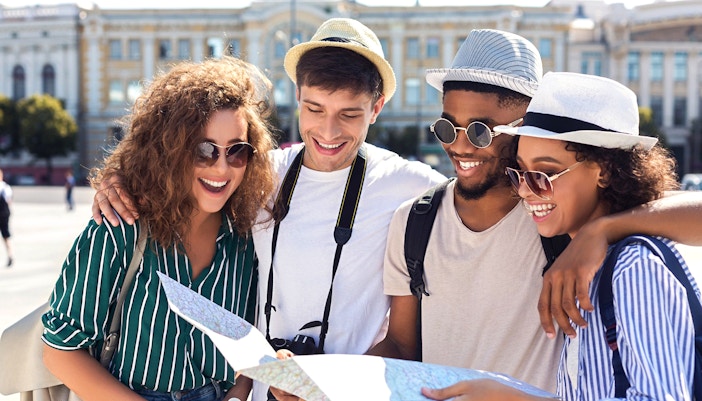 Visitors exploring Schönbrunn Palace Gardens with a map.