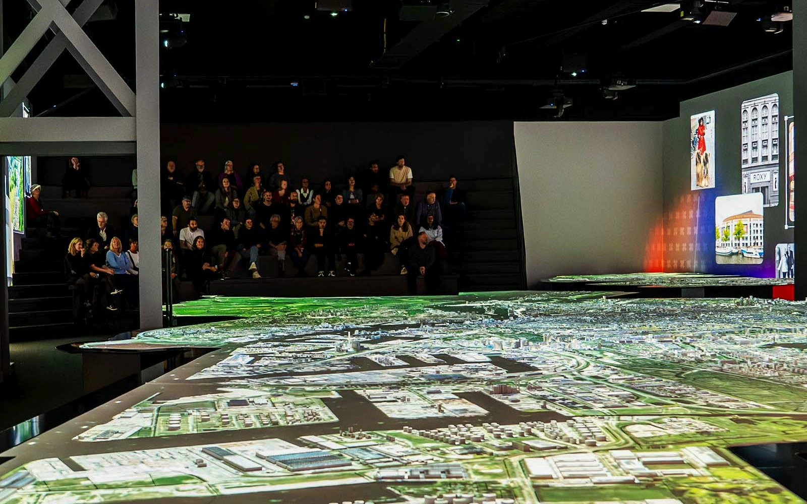Audience viewing interactive map at Amsterdam in Motion exhibit.